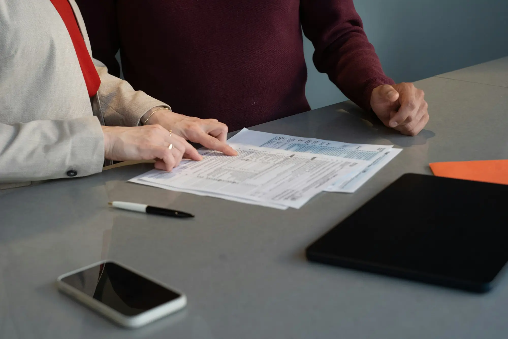 Two people reviewing financial documents together at a table