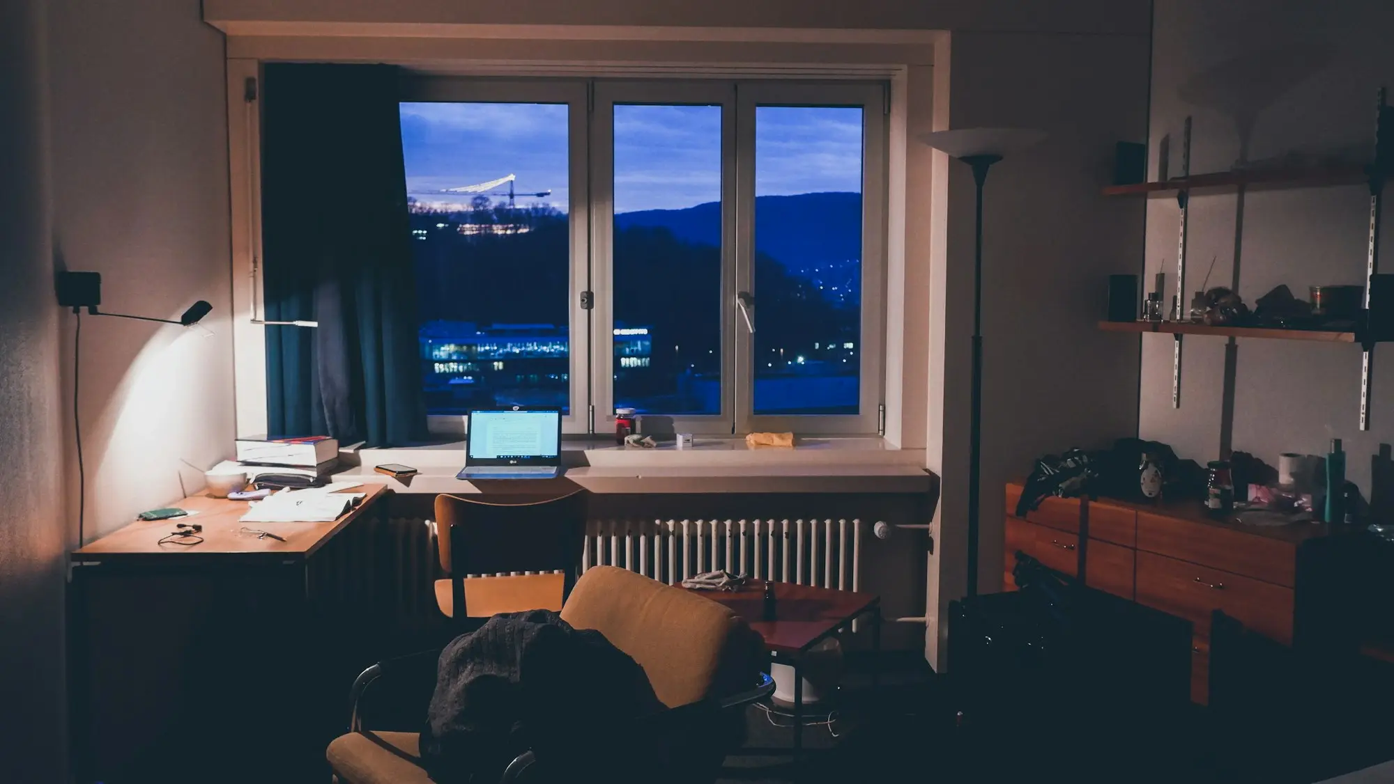 Laptop on a desk in a quiet home office in the evening