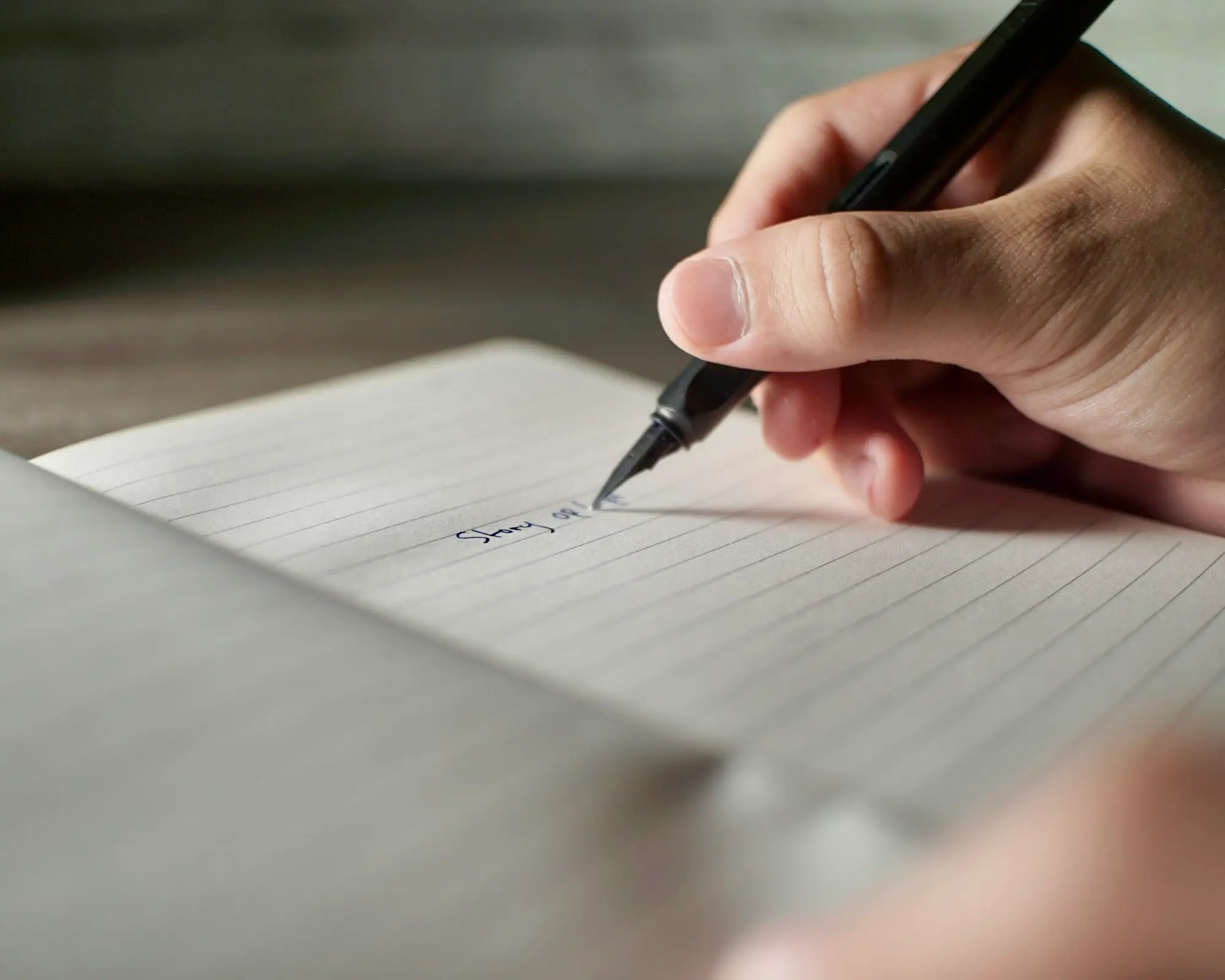 Hand writing a list of options on paper with a pen